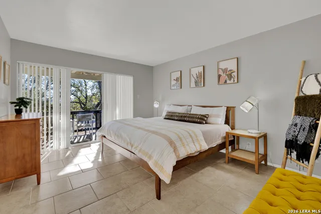 a bedroom with a bed and a couch