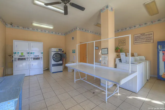 a view of a kitchen with kitchen island stainless steel appliances wooden floor and view living room
