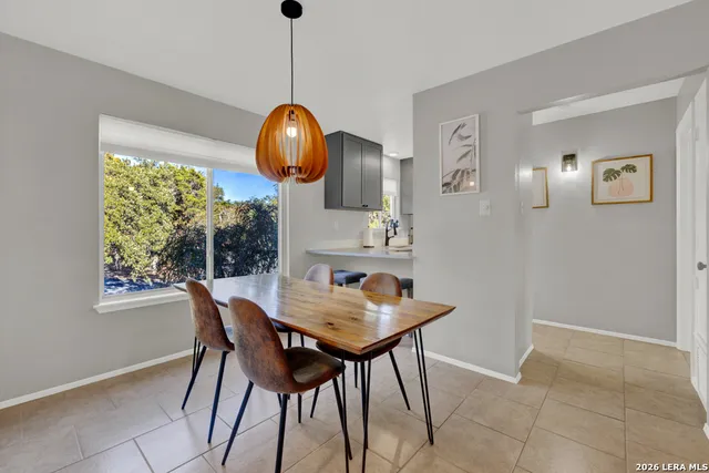 a view of a dining room with furniture and chandelier