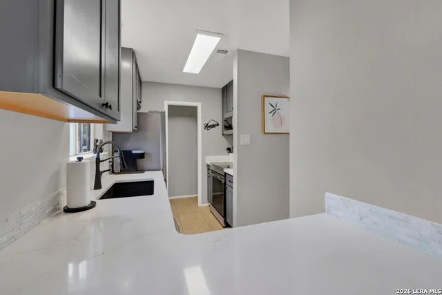 a kitchen with stainless steel appliances granite countertop a refrigerator and a sink