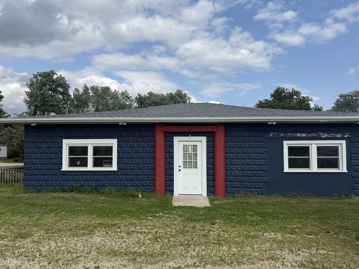 a brick house with a yard in front of it
