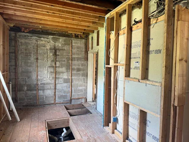 a bathroom with a glass shower door and mirror