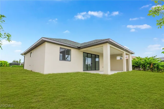 a front view of a house with yard and green space