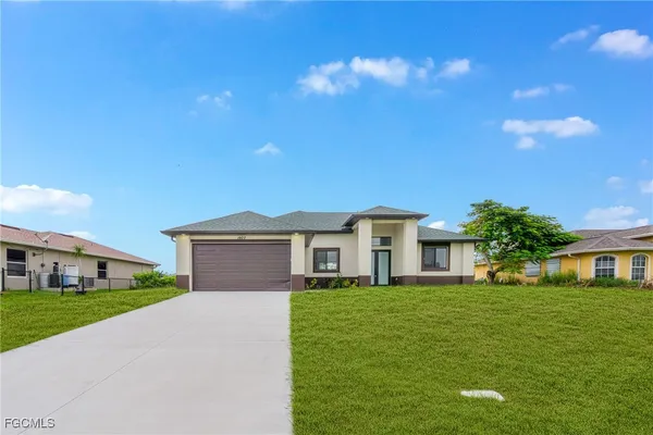 a front view of house with a garden