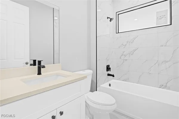 a bathroom with a sink a toilet and a bathtub