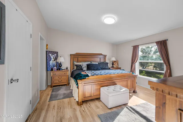 a bedroom with furniture and a large window