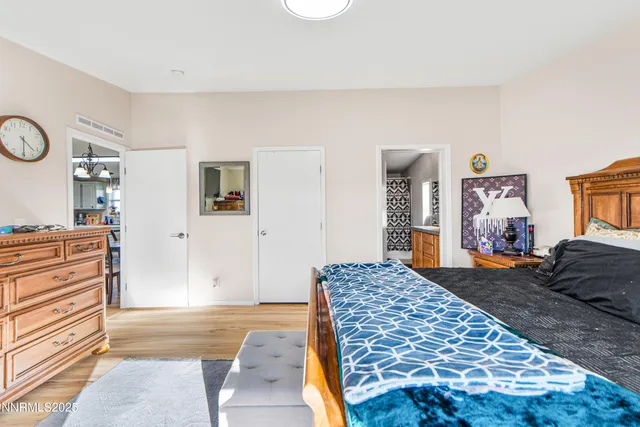 a bedroom with a large bed and closet