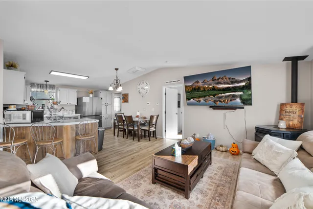 a living room with furniture and kitchen view