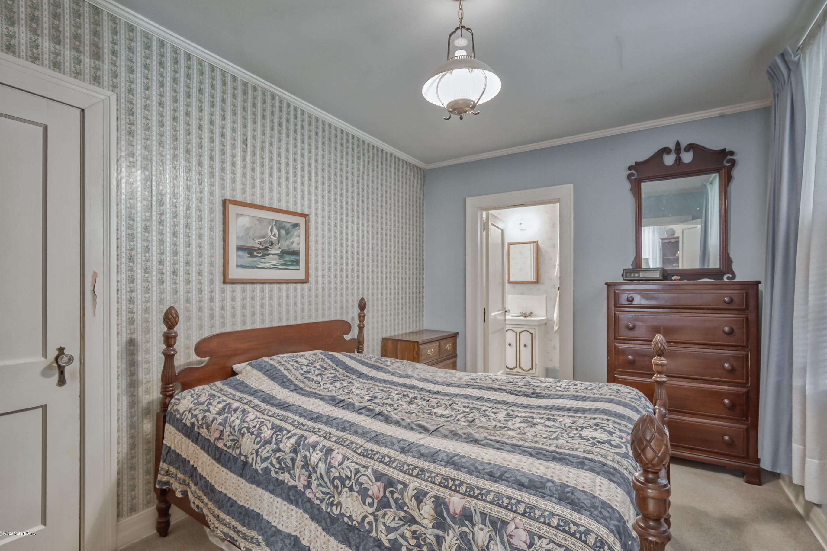 1011 Inwood Terrace Jacksonville, FL 32207 - Photo 13 of 21 a bedroom with a large bed and a chandelier