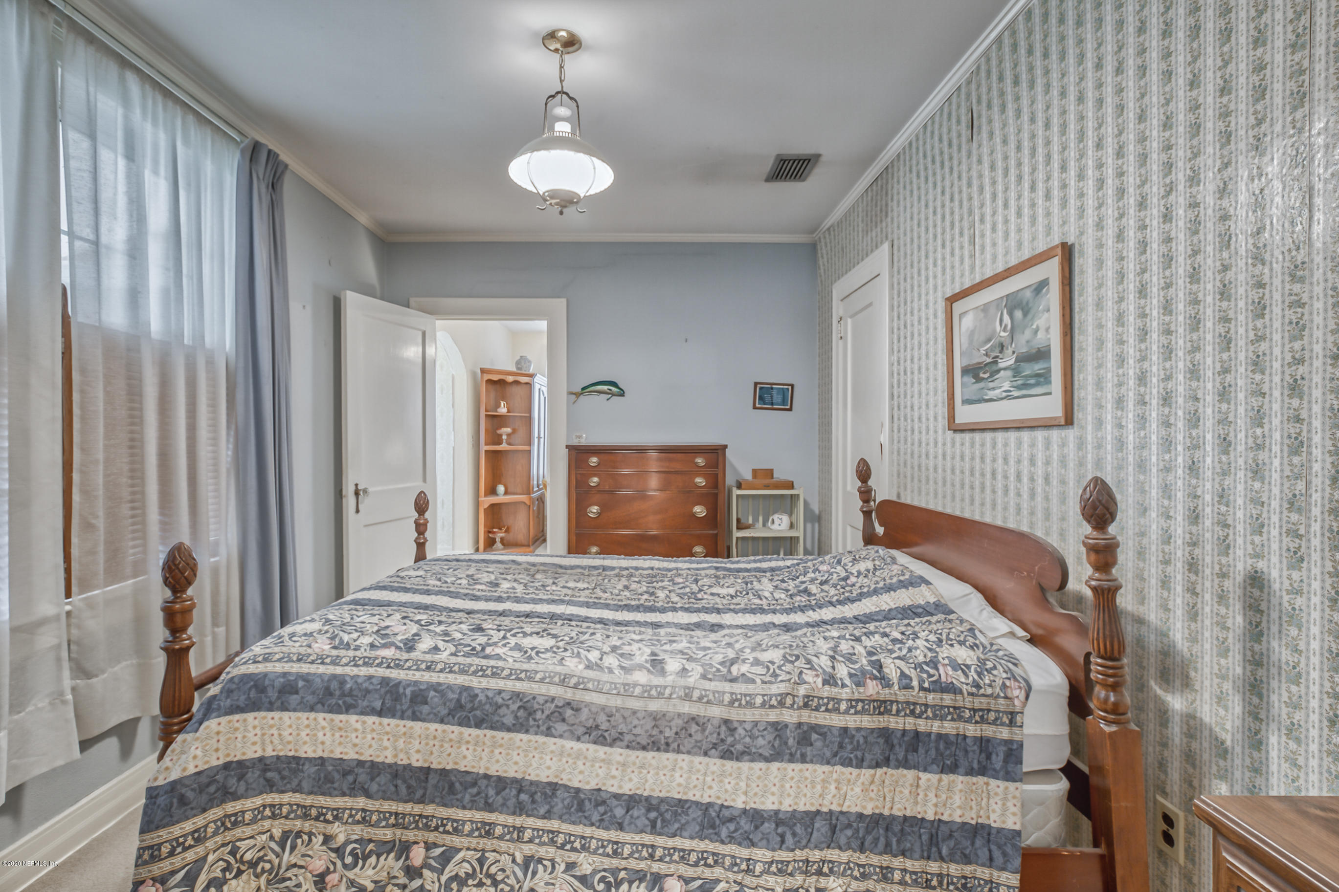 1011 Inwood Terrace Jacksonville, FL 32207 - Photo 4 of 21 a bedroom with a large bed and a chandelier