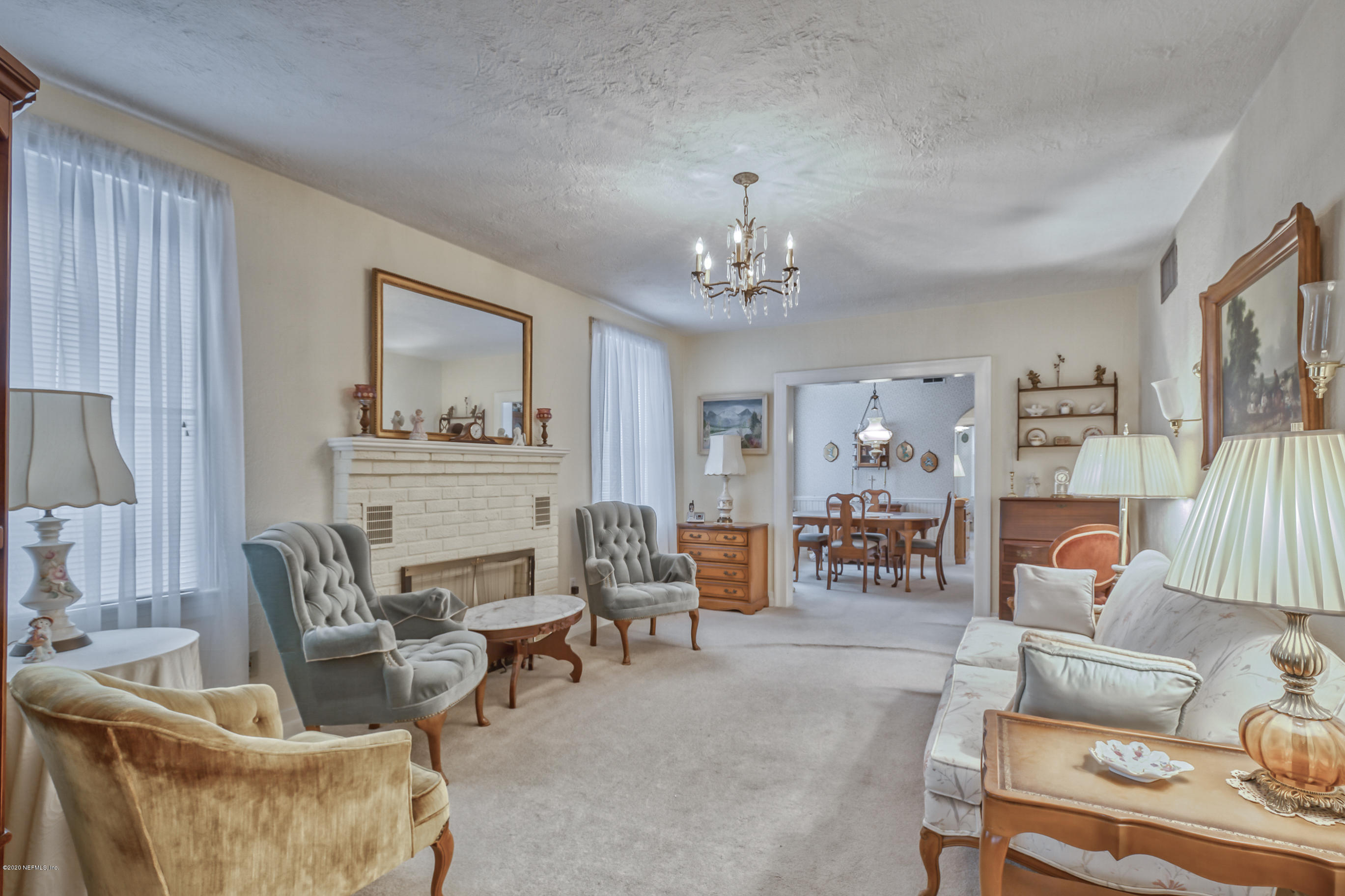 1011 Inwood Terrace Jacksonville, FL 32207 - Photo 8 of 21 a living room with furniture and a chandelier