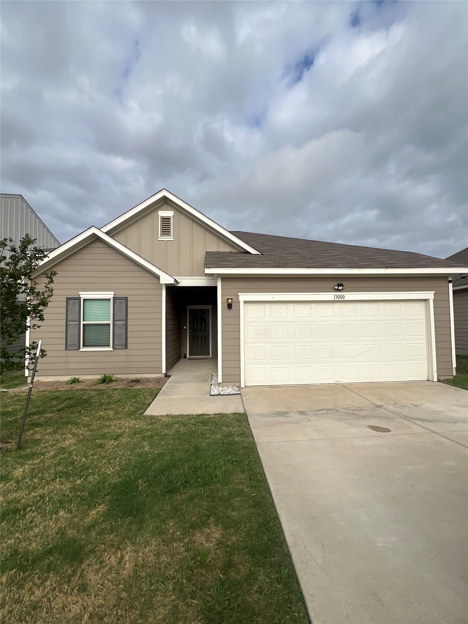 a front view of a house with a yard and garage