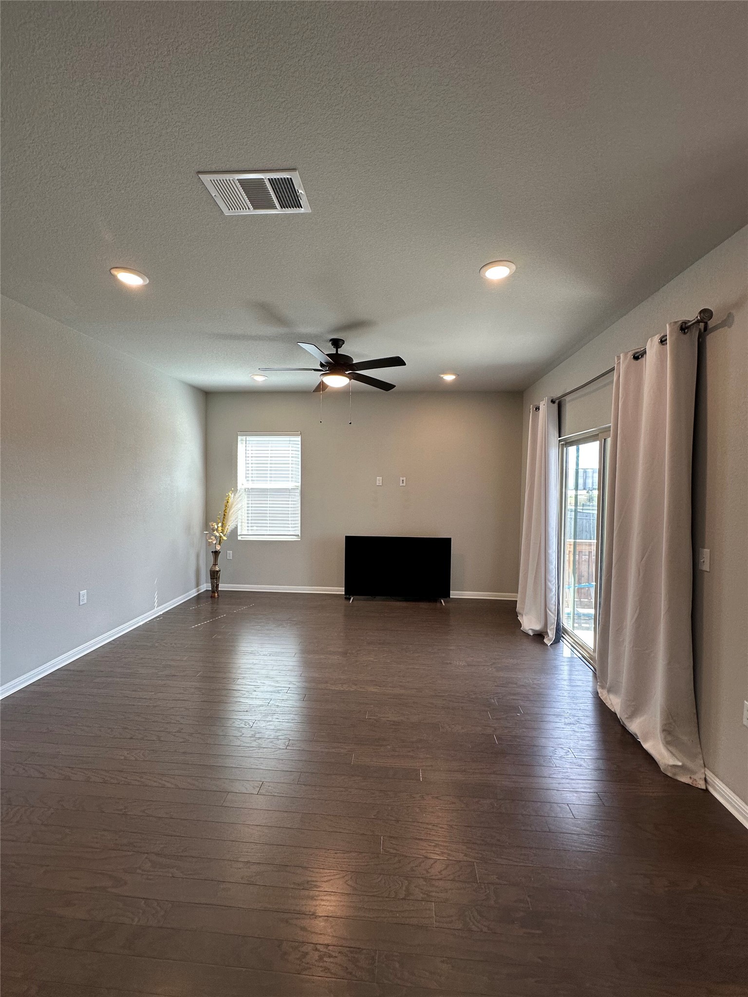 13000 Titanium Street Austin, TX 78754 - Photo 5 of 15 Unfurnished living room with ceiling fan, dark wood-style floors, and recessed lighting