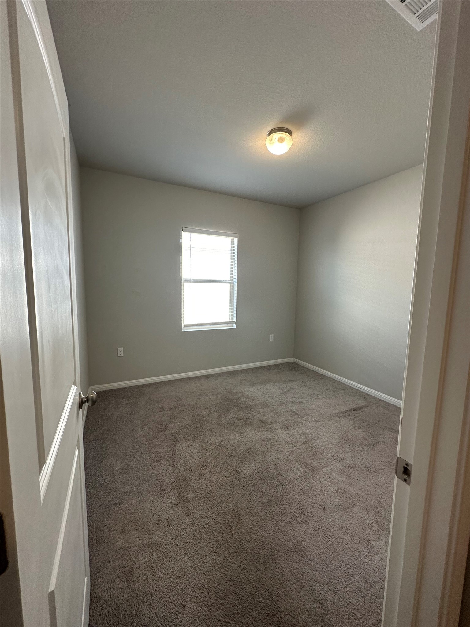 13000 Titanium Street Austin, TX 78754 - Photo 10 of 15 Empty room with carpet and a textured ceiling