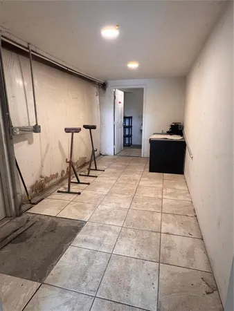 a room with gym equipment and a glass door shower