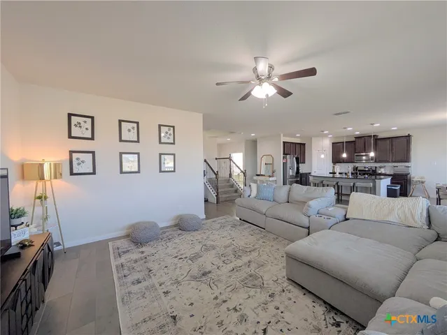 a living room with furniture and kitchen view
