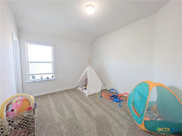 a view of a baby room with toys and stairs