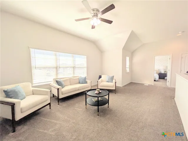 a living room with furniture and a large window with outer view