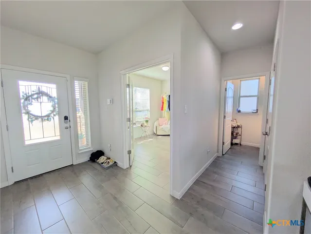 an empty room with wooden floor and a window
