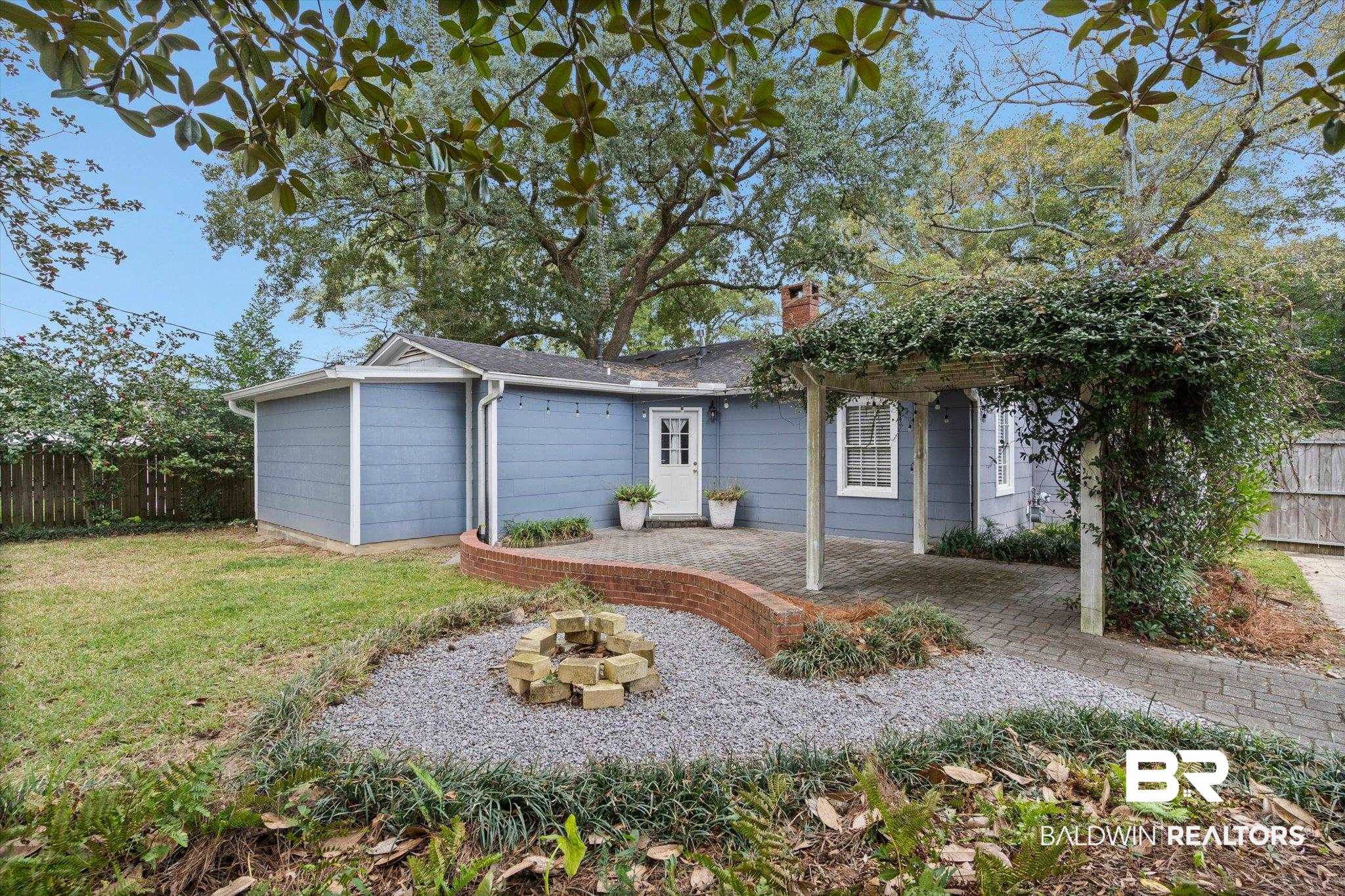11 York Place Mobile, AL 36608 - Photo 20 of 24 View of front facade featuring an outdoor fire pit and a chimney