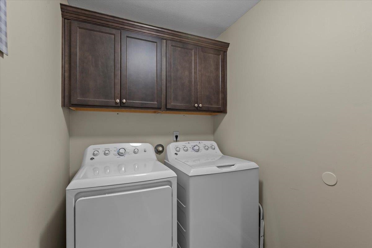10045 Notting Hill Road Memphis, TN 38016 - Photo 13 of 17 Laundry room with independent washer and dryer and cabinets
