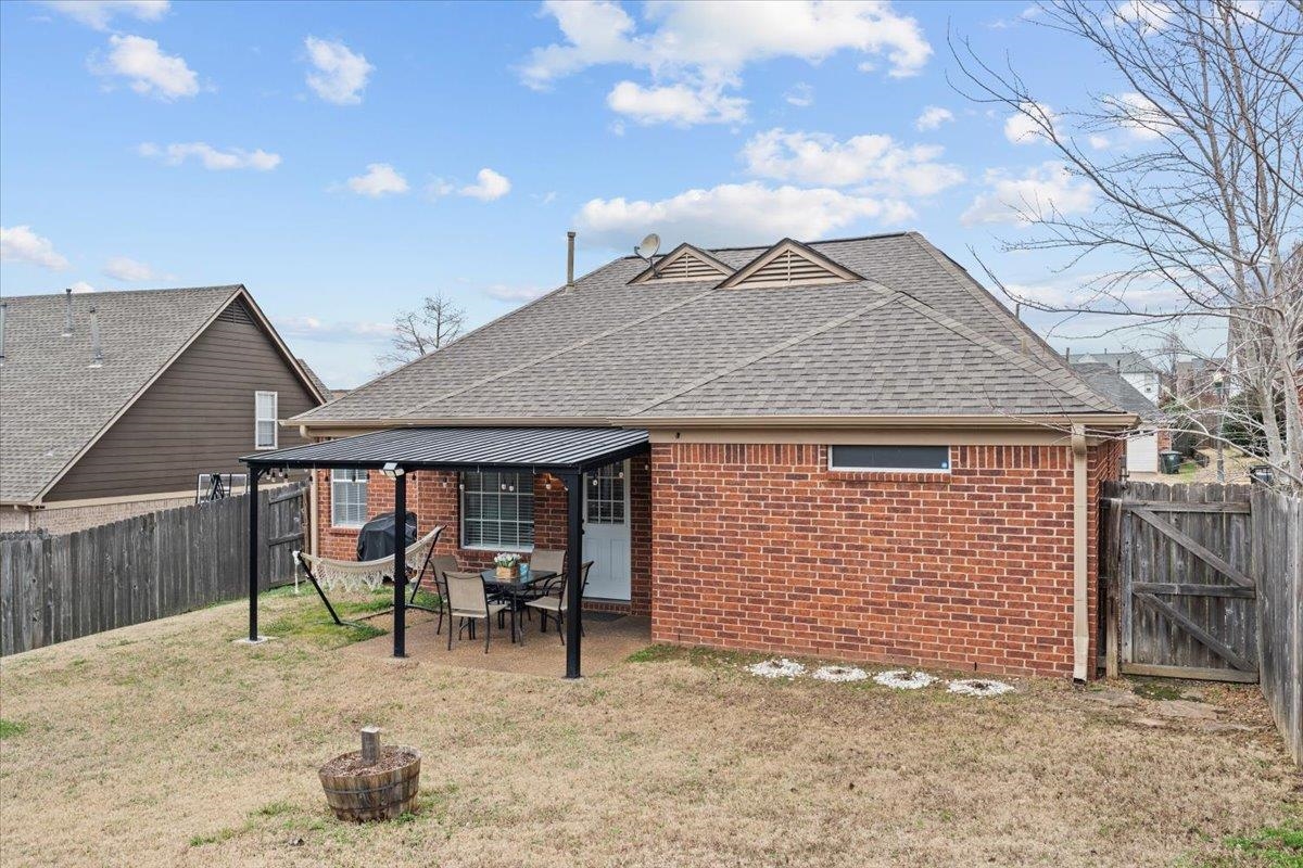 10045 Notting Hill Road Memphis, TN 38016 - Photo 15 of 17 Back of property with a yard and a patio