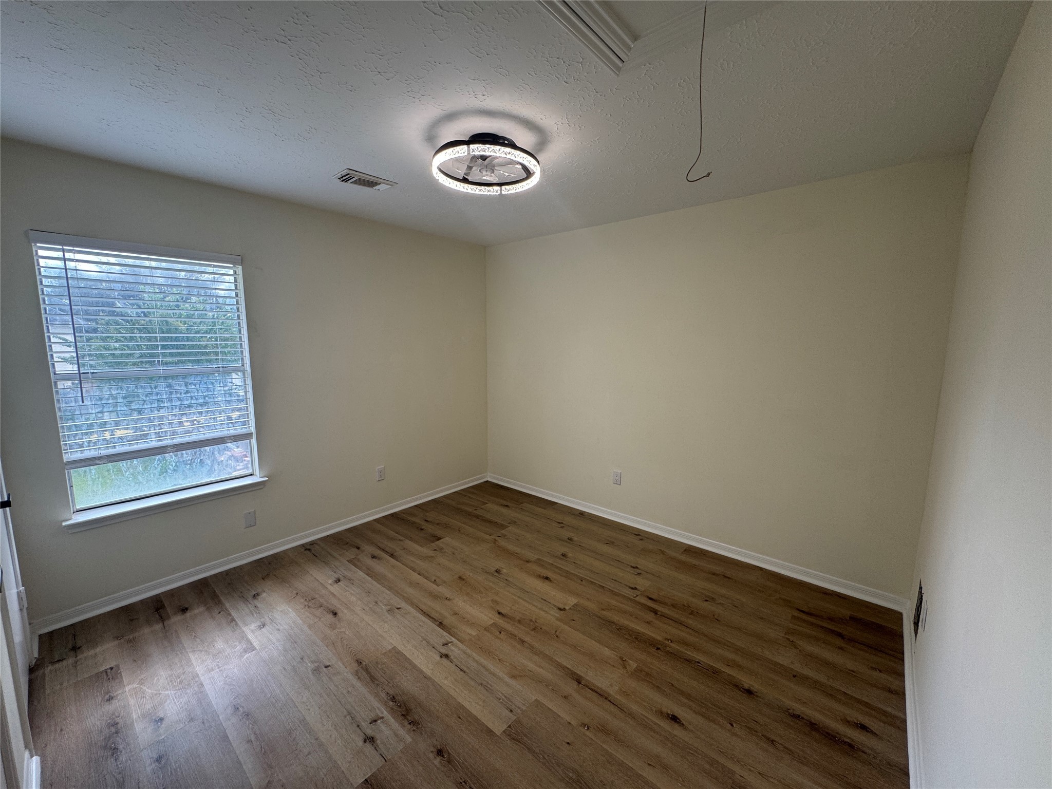 12827 Waybridge Street Sugar Land, TX 77478 - Photo 13 of 23 an empty room with wooden floor and windows