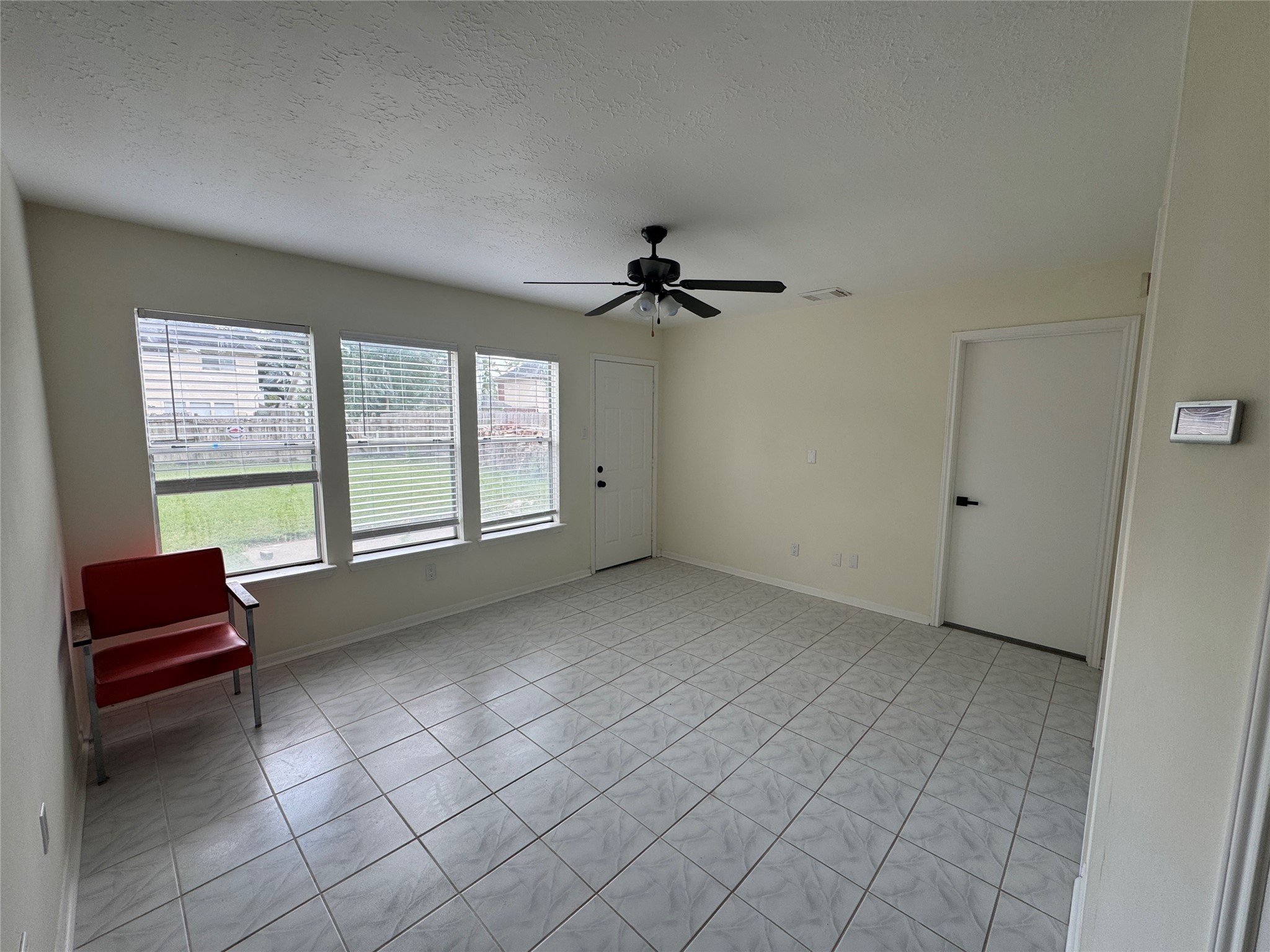 12827 Waybridge Street Sugar Land, TX 77478 - Photo 16 of 23 an empty room with windows and ceiling fan