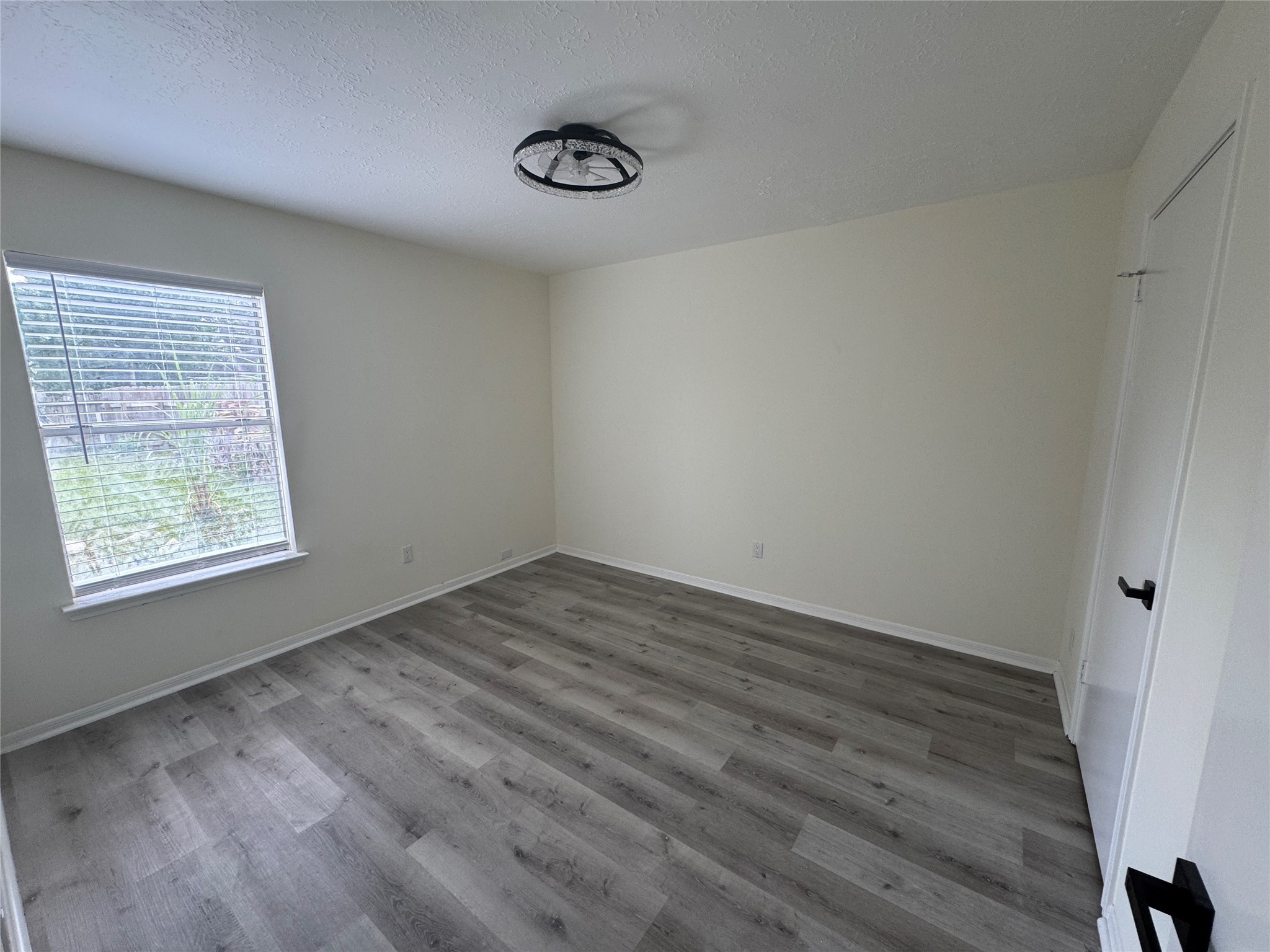 12827 Waybridge Street Sugar Land, TX 77478 - Photo 18 of 23 an empty room with wooden floor and windows