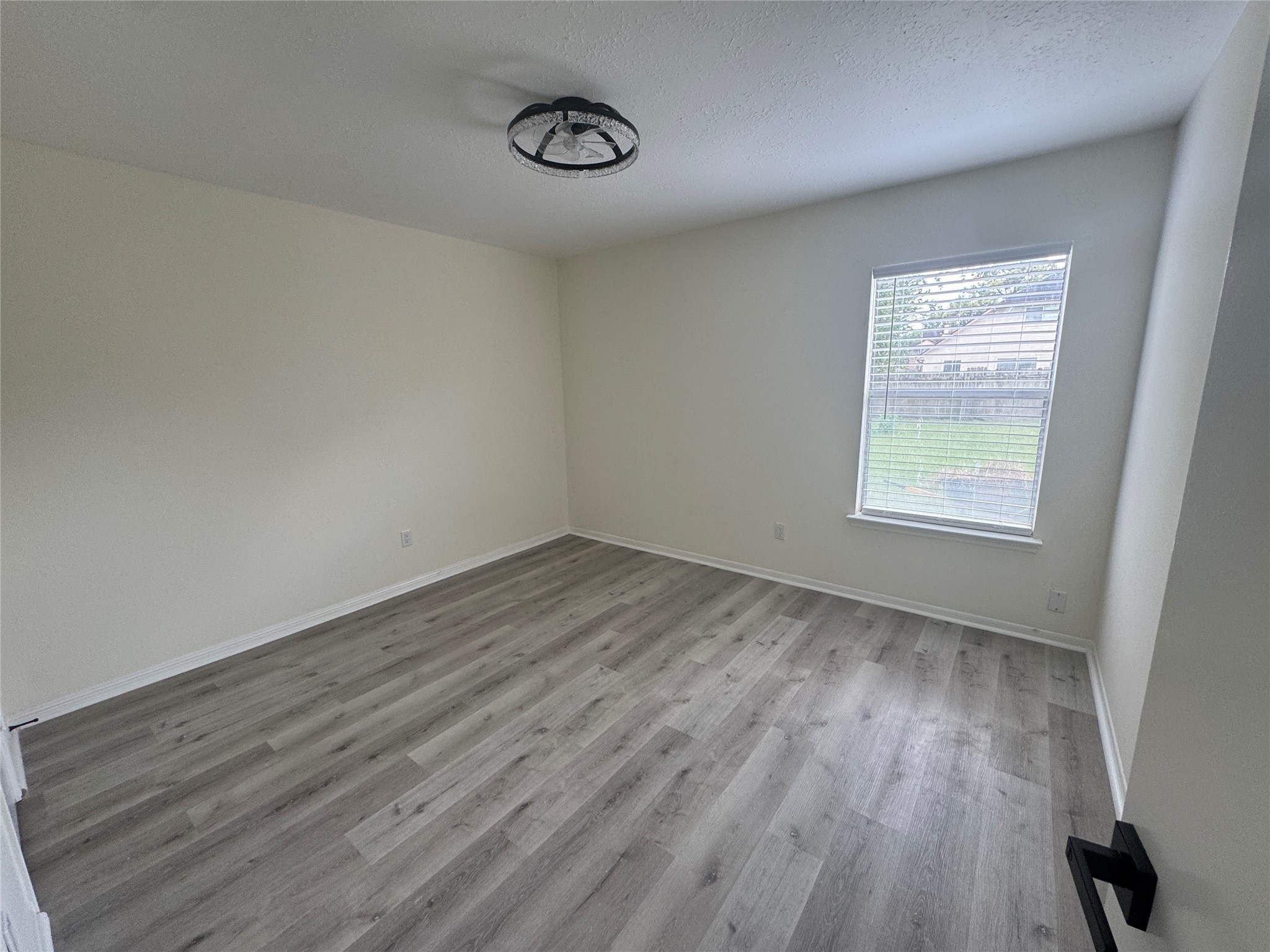 12827 Waybridge Street Sugar Land, TX 77478 - Photo 20 of 23 an empty room with wooden floor and windows