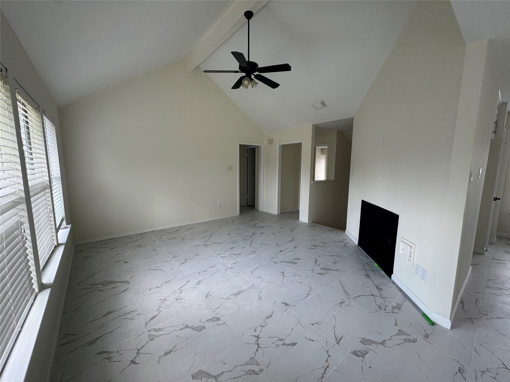 12827 Waybridge Street Sugar Land, TX 77478 - Photo 3 of 23 an empty room with a fireplace and windows