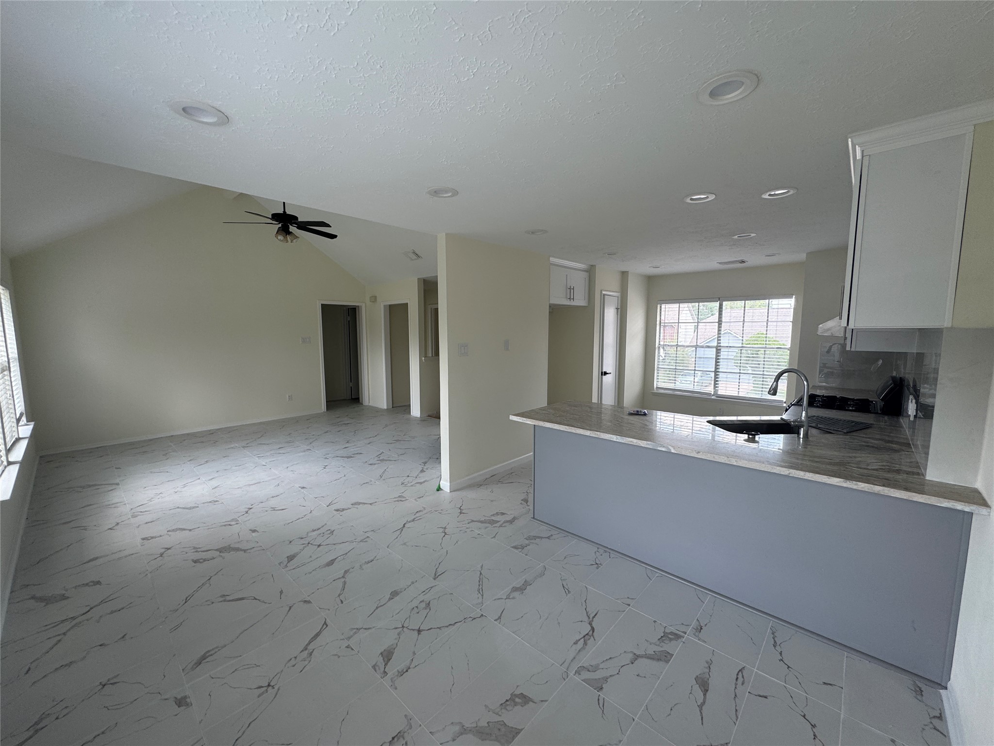 12827 Waybridge Street Sugar Land, TX 77478 - Photo 5 of 23 a large living room with stainless steel appliances granite countertop a couch and a stove top oven