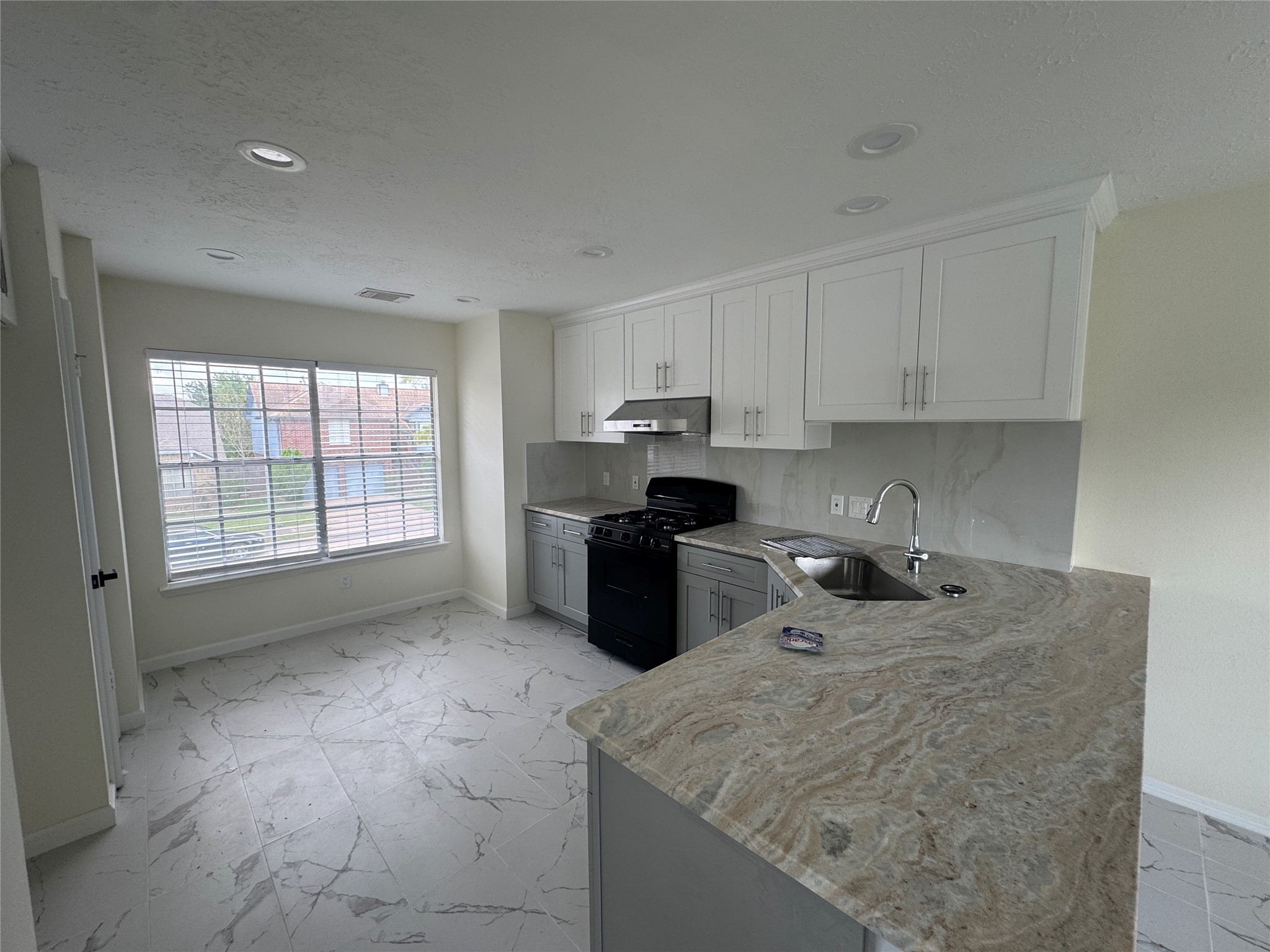 12827 Waybridge Street Sugar Land, TX 77478 - Photo 6 of 23 a kitchen with stainless steel appliances granite countertop a sink stove and refrigerator