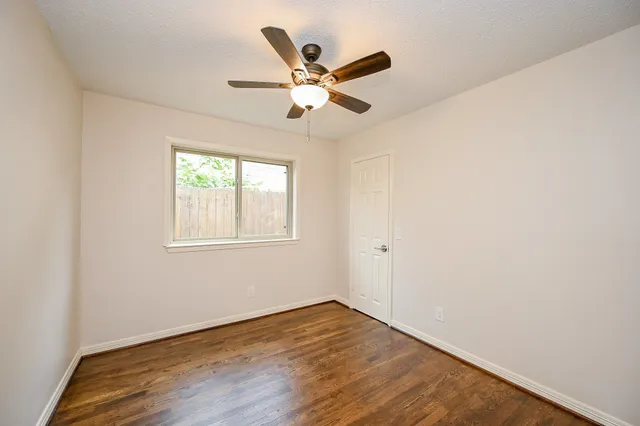 a view of room with window and ceiling fan