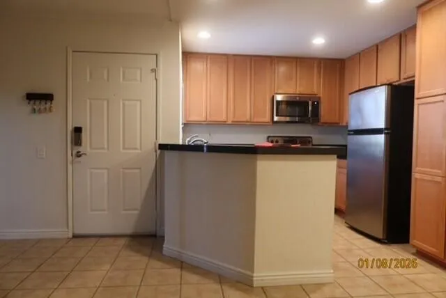 a kitchen with a refrigerator and a microwave