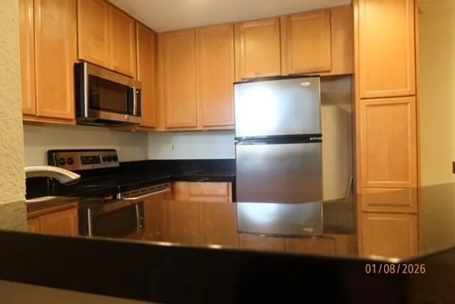 a bathroom with a granite countertop sink and mirror