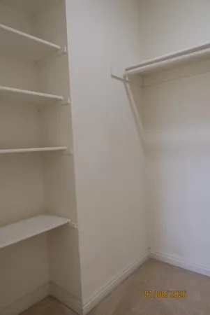 a view of an empty walk in closet