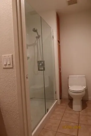 a bathroom with a toilet and a shower