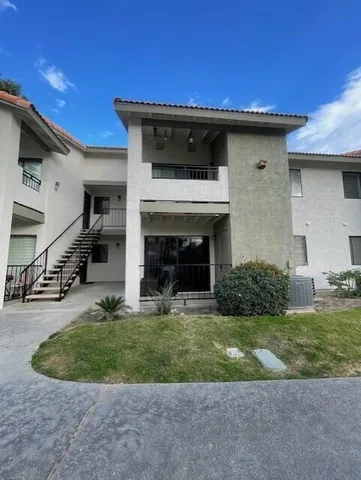 a view of a patio with table and chairs potted plants