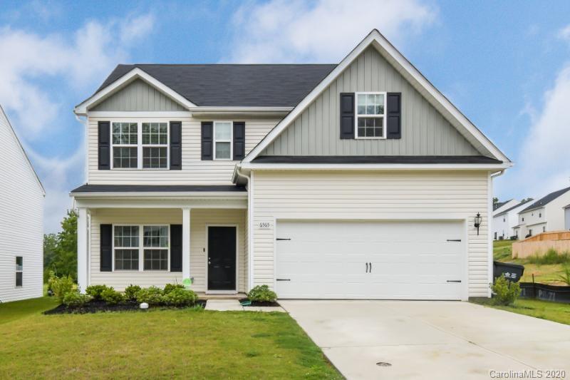 6565 Paw Village Road Charlotte, NC 28214 - Photo 1 of 26 a front view of a house with a yard and garage
