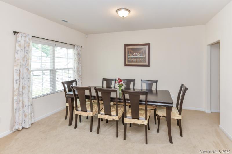 6565 Paw Village Road Charlotte, NC 28214 - Photo 2 of 26 a view of a dining room with furniture and a window