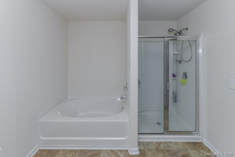 6565 Paw Village Road Charlotte, NC 28214 - Photo 12 of 26 a bathroom with a bathtub