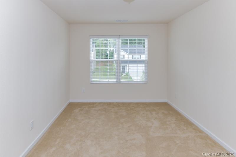 6565 Paw Village Road Charlotte, NC 28214 - Photo 15 of 26 an empty room with a window