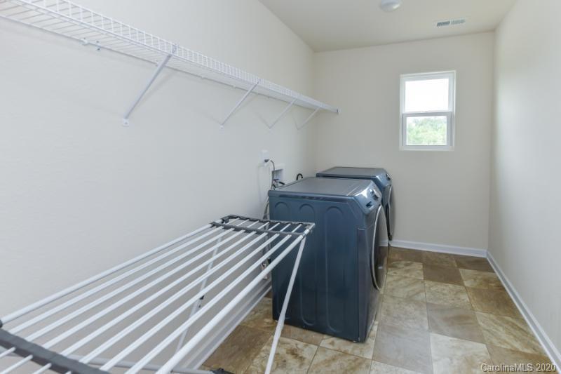6565 Paw Village Road Charlotte, NC 28214 - Photo 16 of 26 a bedroom with a bed and a window