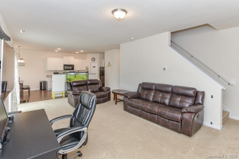 6565 Paw Village Road Charlotte, NC 28214 - Photo 18 of 26 a living room with furniture and kitchen view
