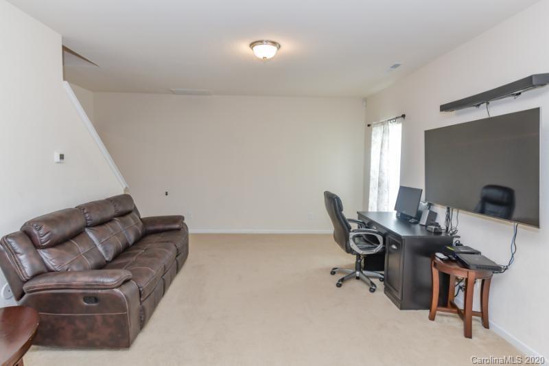 6565 Paw Village Road Charlotte, NC 28214 - Photo 19 of 26 a work room with furniture and a flat screen tv
