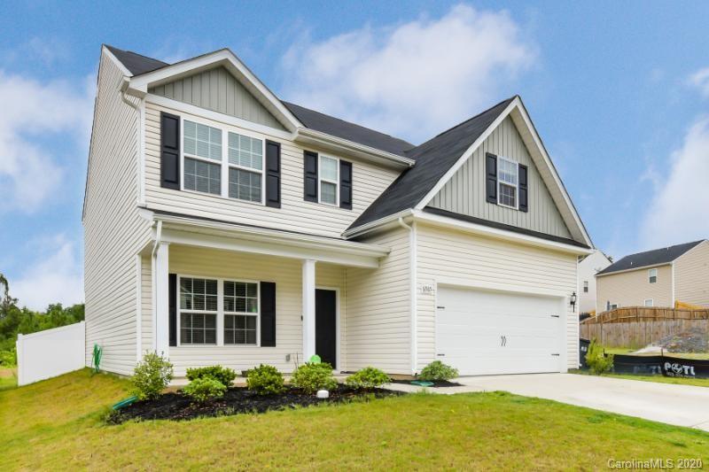 6565 Paw Village Road Charlotte, NC 28214 - Photo 22 of 26 a front view of a house with a yard and garage