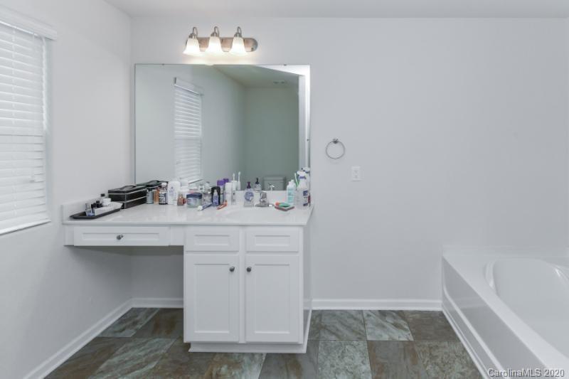 6565 Paw Village Road Charlotte, NC 28214 - Photo 23 of 26 a bathroom with a sink and a mirror