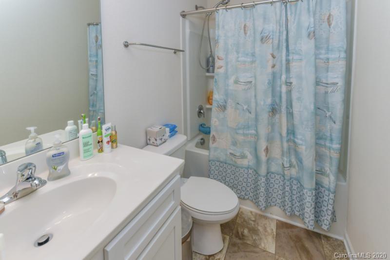 6565 Paw Village Road Charlotte, NC 28214 - Photo 24 of 26 a bathroom with a sink a toilet and shower