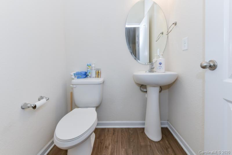 6565 Paw Village Road Charlotte, NC 28214 - Photo 25 of 26 a bathroom with a sink toilet and a mirror